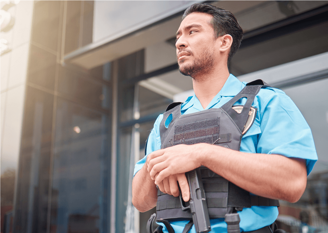 Man in uniform holding a weapon