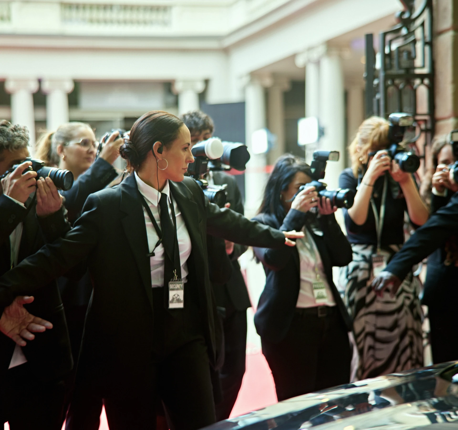 Bodyguards handling media at red carpet event
